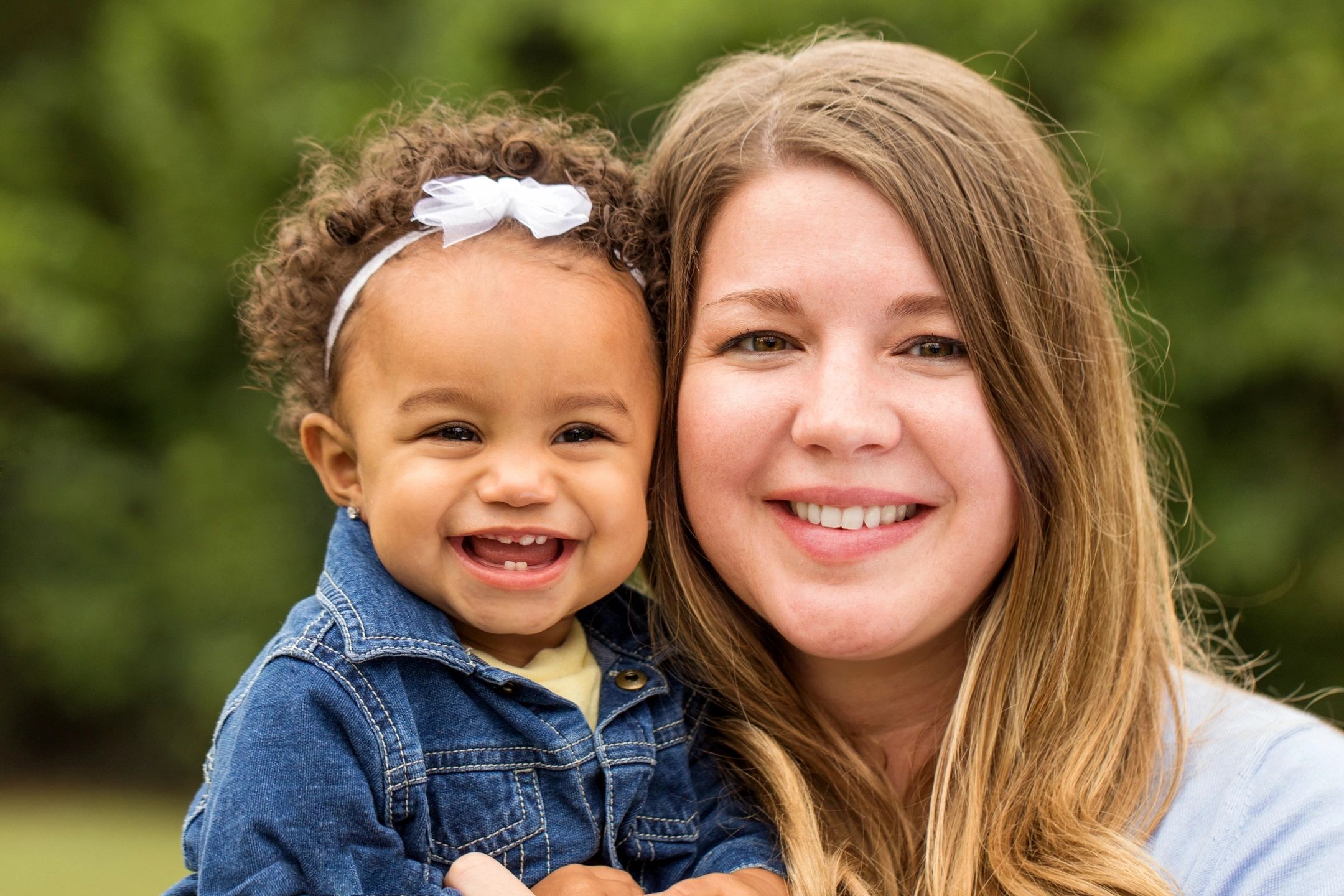 Smiling mother and child enjoying a happy moment outdoors.